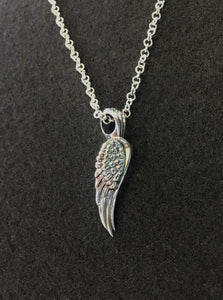 glide pendant top with small silver chain. meaning : rise above a challenge.